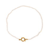 Pearl choker necklace with a gold clasp on a white background