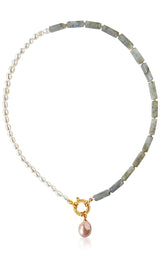Necklace with pearls and green stones on a white background