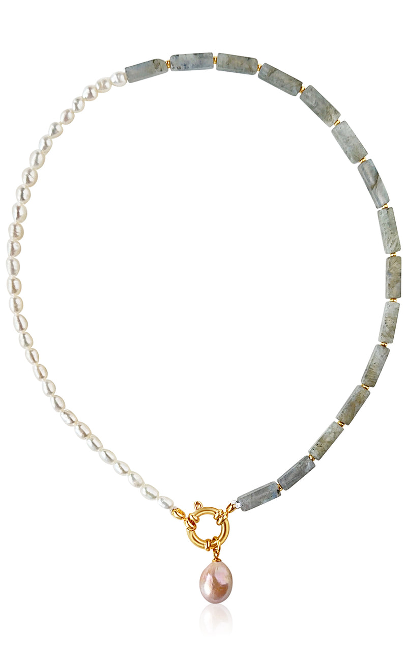 Necklace with pearls and green stones on a white background